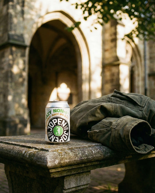 Jopen Nonnetje Hazy can on a stone bench outside the Jopenkerk in Haarlem, with a folded canvas jacket