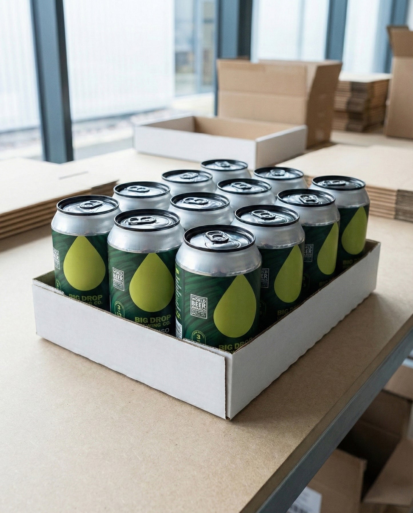 Twelve Big Drop Paradiso Citra IPA cans arranged on concrete background