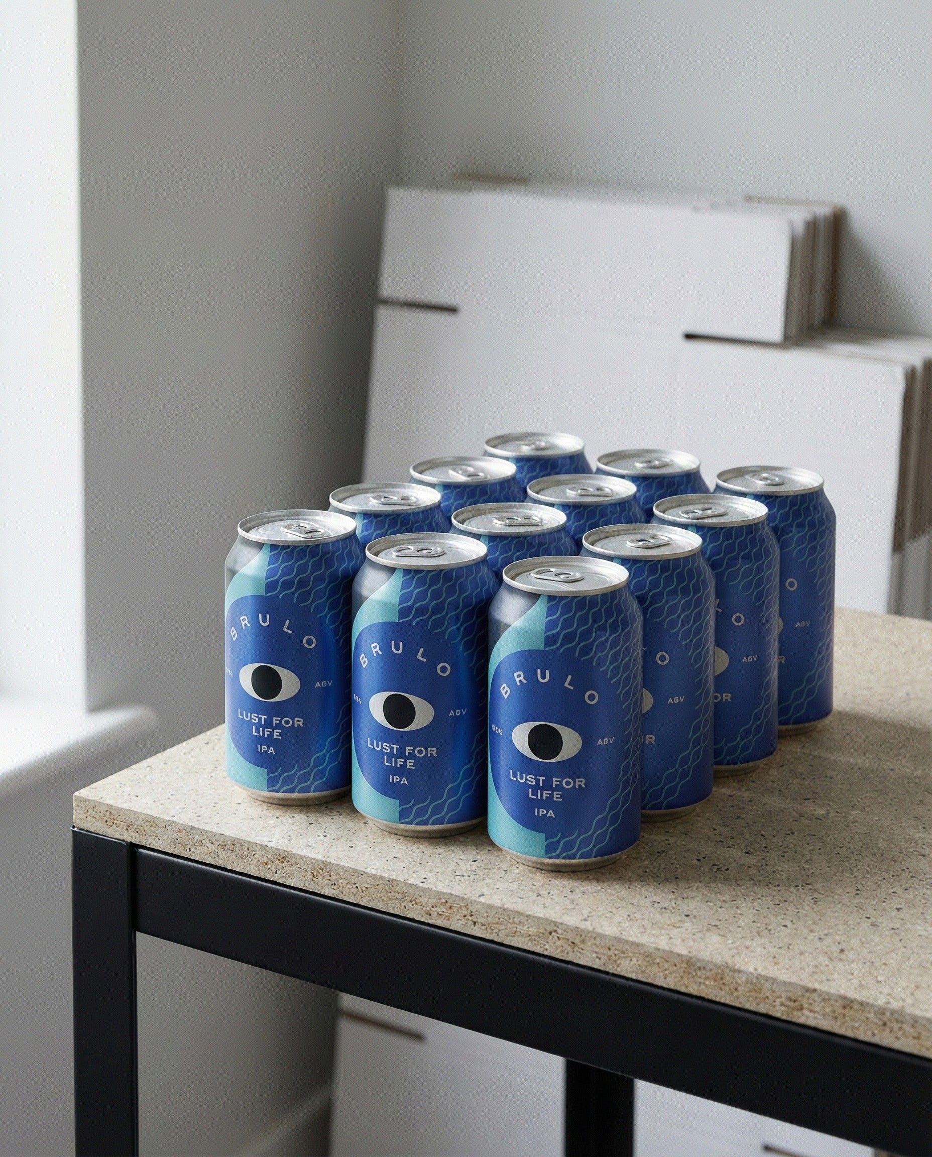 Twelve Brulo Lust for Life cans arranged on concrete background