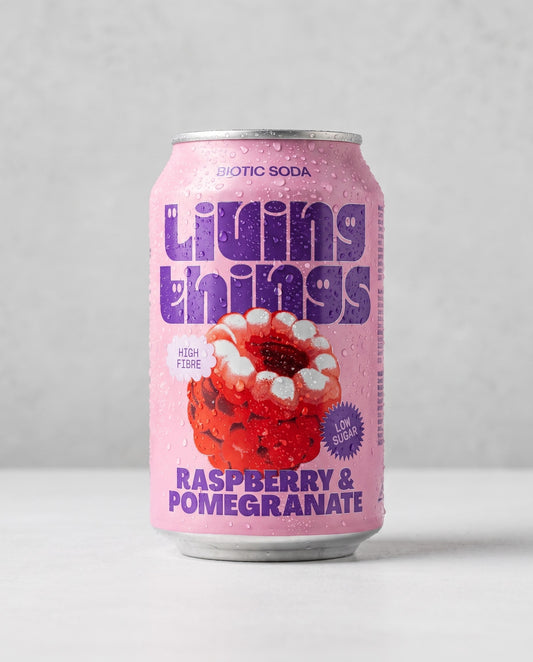 Living Things Raspberry & Pomegranate biotic soda can front view on concrete background