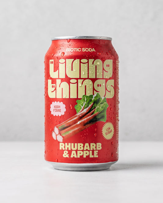 Living Things Rhubarb & Apple biotic soda can front view on concrete background