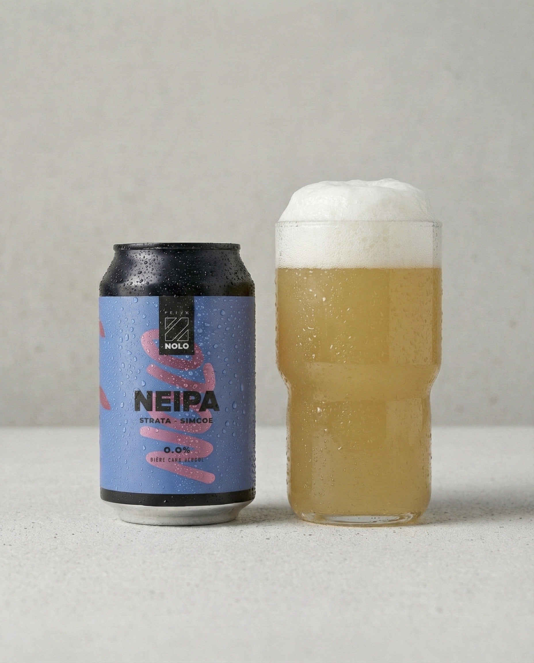 Prizm NOLO NEIPA poured into a tulip glass with foam head