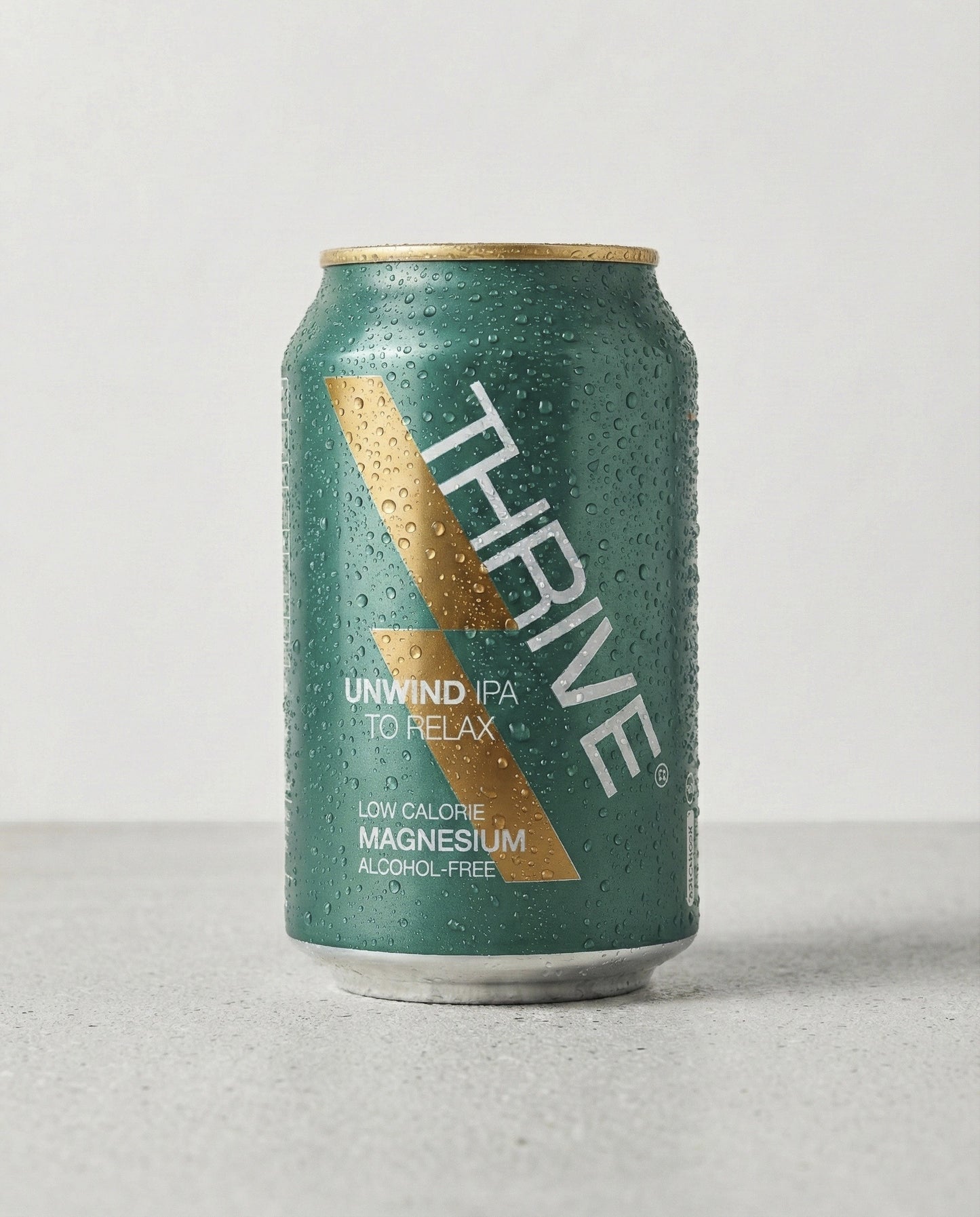 Thrive Unwind Beer can front view on concrete background
