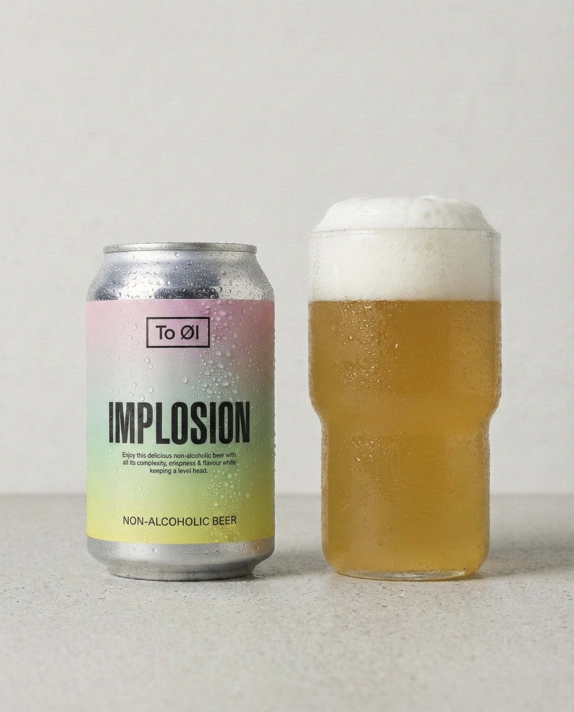 To Øl Implosion IPA poured into a glass with foam head