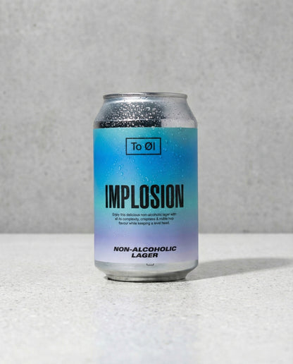 To Øl Implosion Lager can front view on concrete background