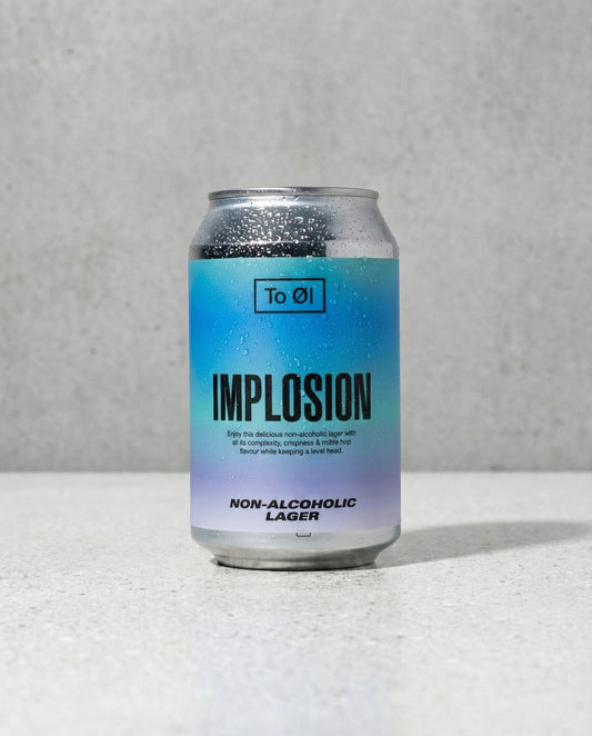 To Øl Implosion Lager can front view on concrete background