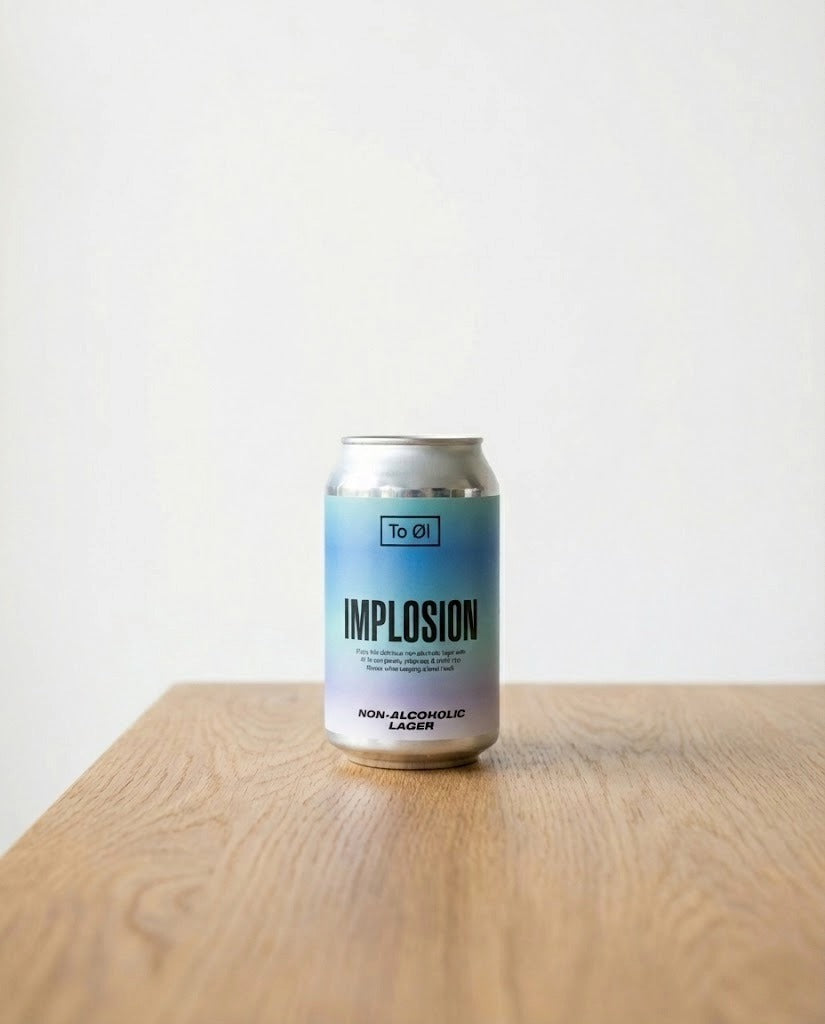 To Øl Implosion Lager can on wooden workbench in pottery studio with clay bowls, tools, glass jar, canvas apron