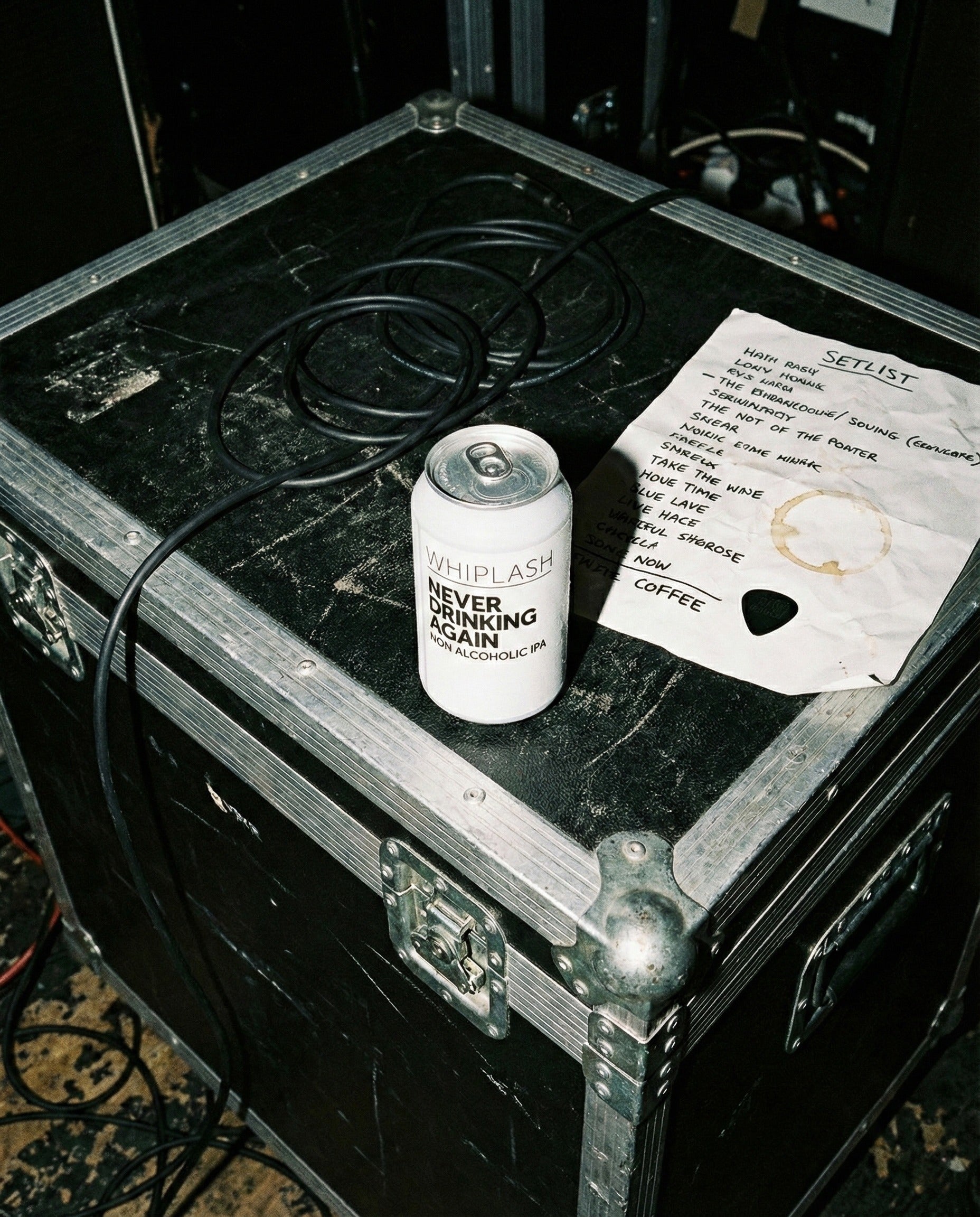 Whiplash Never Drinking Again can on console table with turntable, headphones, vinyl records by sunlit window